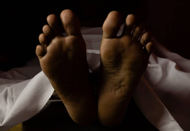 Feet of an Indian or Asian person laying dead Feet of an Indian or Asian person laying dead during COVID-19 or corona virus outbreak dead person stock pictures, royalty-free photos & images