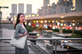 Fashionable Asian woman looking at urban big and modern city lights