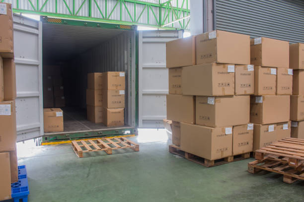 istock loading shipment carton boxes and goods on wooden pallet at loading dock from container 1269127111