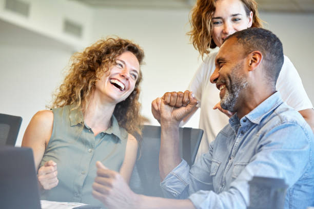 istock Smiling business people sitting in office 1269127324