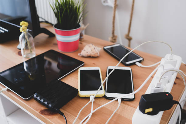 Charged mobile phones and tablets chargers and mobile phones on the table, technoliji charging system. wooden flash drive stock pictures, royalty-free photos & images