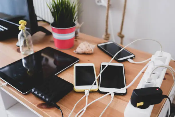 chargers and mobile phones on the table, technoliji charging system.