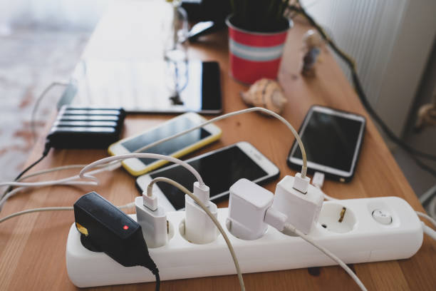 Charged mobile phones and tablets chargers and mobile phones on the table, technoliji charging system. wooden flash drive stock pictures, royalty-free photos & images
