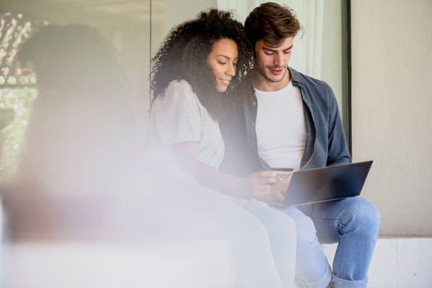 istock Couple doing online shopping with laptop 1269131168