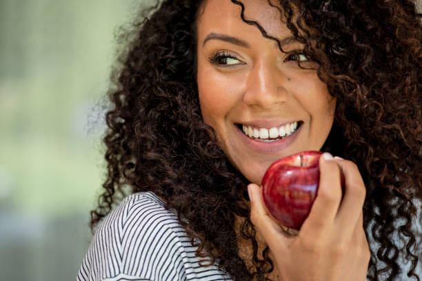 istock Young woman eating apple 1269131215