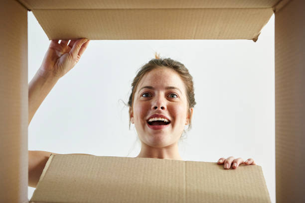 istock Woman opening cardboard box 1269131539
