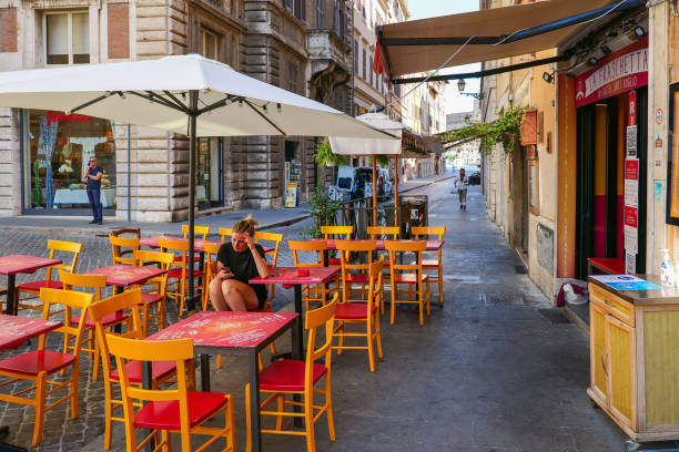 Rome, Italy - 27 November, 2022: tourists enjoy food and drinks in a typical Italian restaurant in downtown Rome at Navona Square
