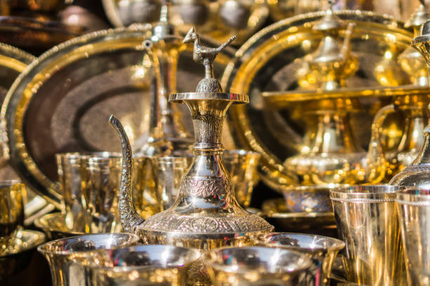 A display of decorative brass objects reflecting light stock photo