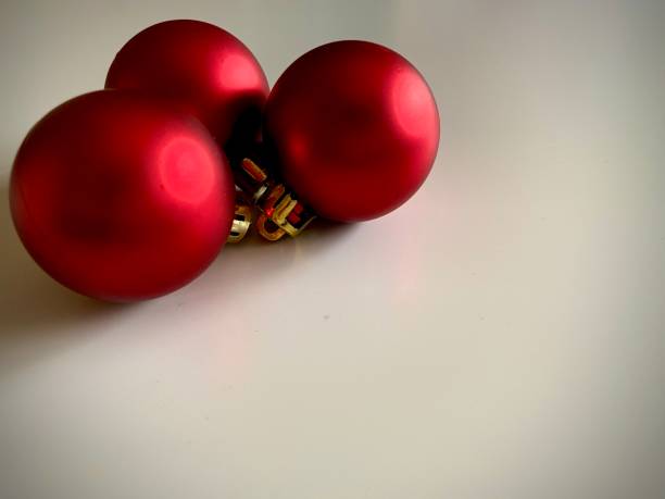 istock Three red Christmas balls on white background . Closeup shot : selective focus. Copy space 1269133608