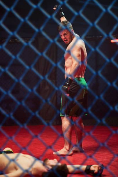 istock MMA fighter celebrating win. Cheering and raising arm 1269133869