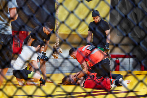 istock Accident during martial arts training. Helping unconcious female fighter 1269133982
