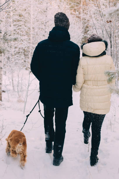 istock Young couple walking with dog 1269134097