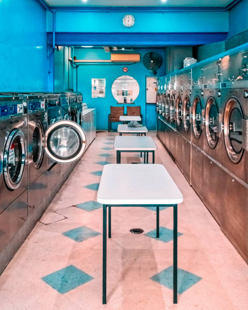 Rows of industrial laundry machines in the large laundromat