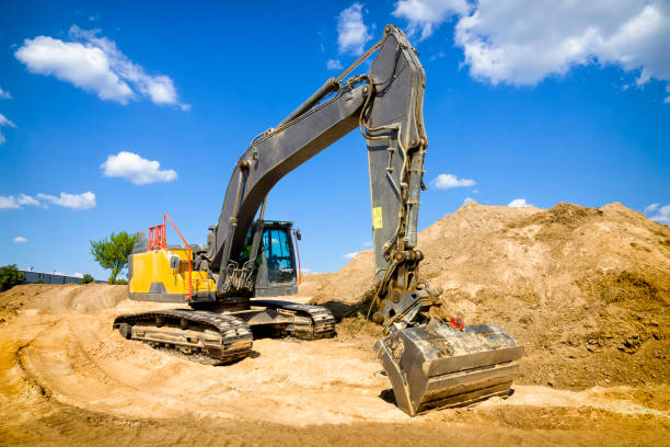 istock Yellow excavator on a highway construction site 1269136871