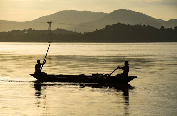 Fisherman in the Brahmaputra river Fisherman fishing in the Brahmaputra river at sunset, in Guwahati, Friday, 27 August 2020. brahmaputra river stock pictures, royalty-free photos & images