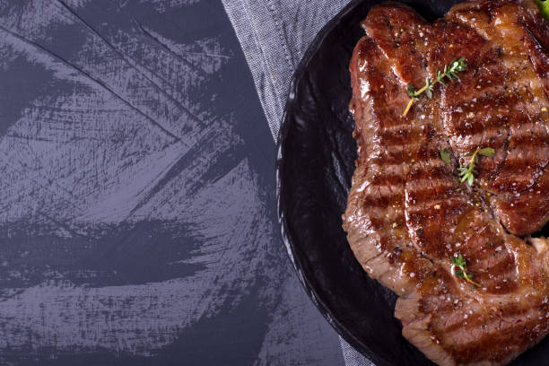 istock Grilled beef steak served on the stone plate 1269144333