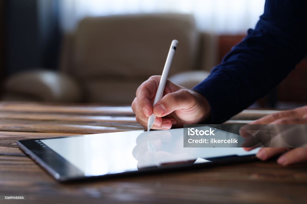 Businessman Signing Digital Contract On Tablet Using Stylus Pen Signing Stock Photo