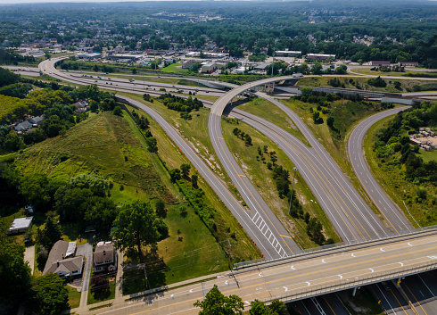 High above highways, interchanges the roads band and the interstate takes you on a fast transportation highway in Cleveland Ohio US drone view