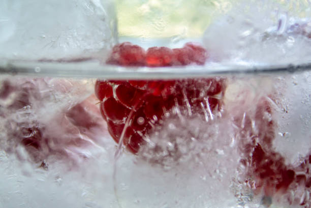 istock water with raspberries and ice in a glass 1269146477