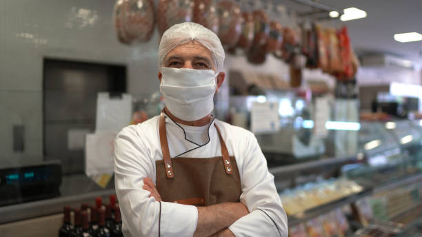 istock Portrait of a confident baker or butcher in a store using face mask 1269146551