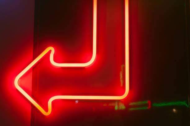 istock Red neon arrow on dark background. 1269147872
