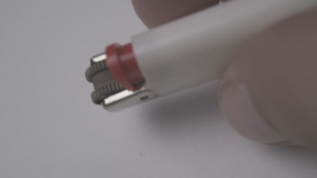 man taps with white lighter light surface extreme close view