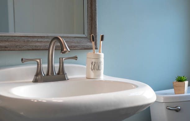 istock Earth friendly bamboo toothbrushes on the bathroom sink 1269151262
