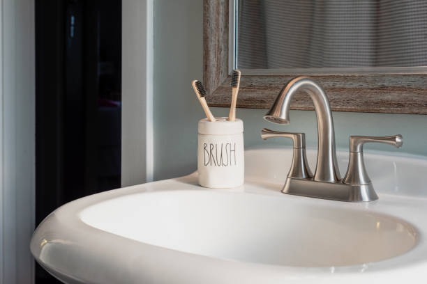Bamboo toothbrushes in a ceramic holder that says 