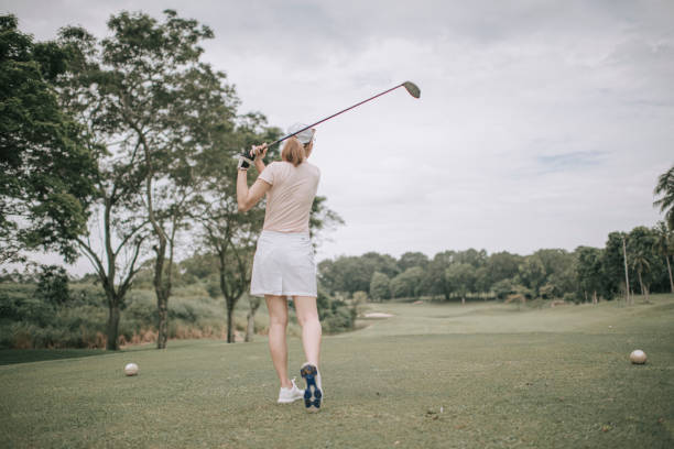 istock asian chinese female golfer teeing off at golf course rear view 1269152536