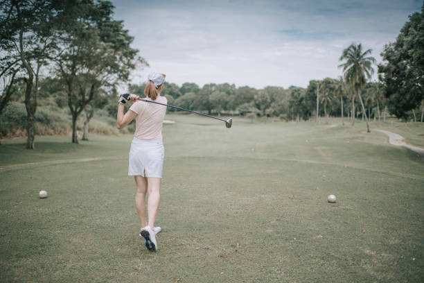 istock asian chinese female golfer teeing off at golf course rear view 1269152552