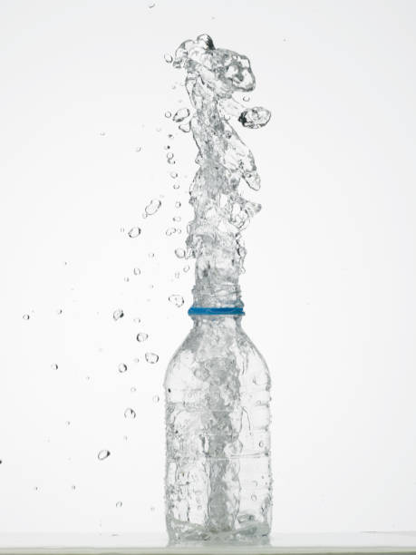 istock Water in glass bottle splashing 1269152768