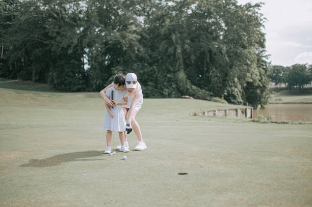 istock asian chinese parent golfer teaching daughter playing golf at golf course weekend 1269153338