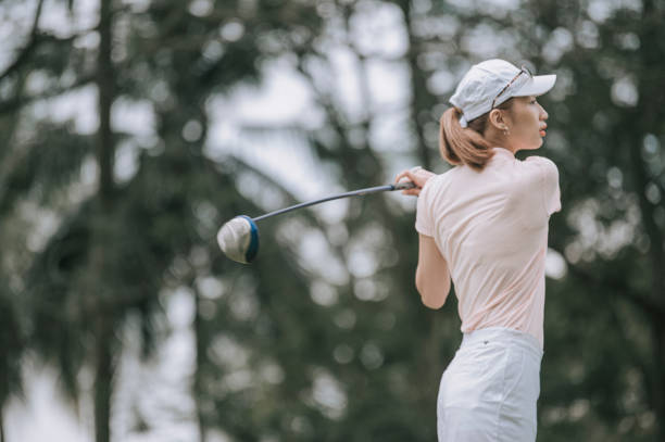 istock Asian chinese female golfer playing golf teeing off 1269153363