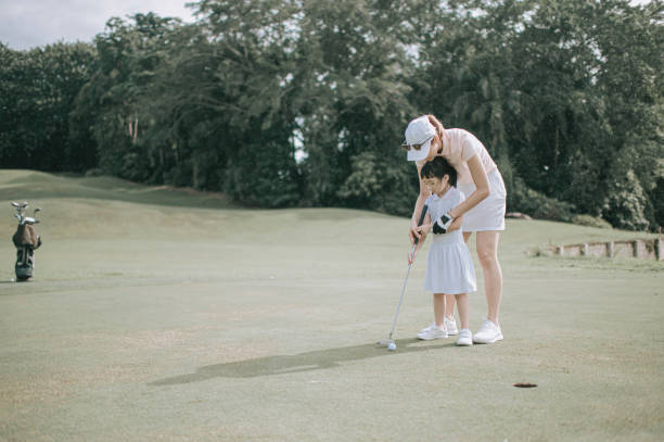 istock asian chinese parent golfer teaching daughter playing golf at golf course weekend 1269153381