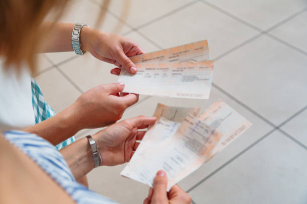 istock Beautiful female hands with paper train tickets 1269153477