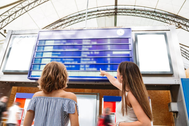 istock Girls searching for a train on schedule at train station 1269153485