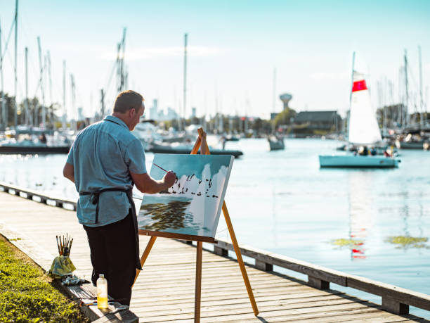 istock Man painting at the Lake shore 1269153759