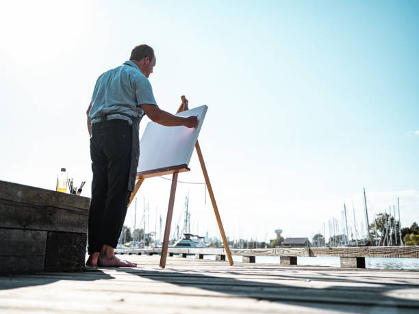 istock Man painting at the Lake shore 1269153932