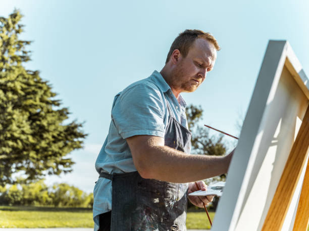istock Man painting at the Lake shore 1269154598