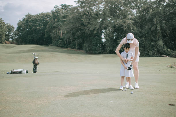 istock asian chinese parent golfer teaching daughter playing golf at golf course weekend 1269154609
