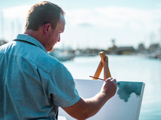 istock Man painting at the Lake shore 1269154627