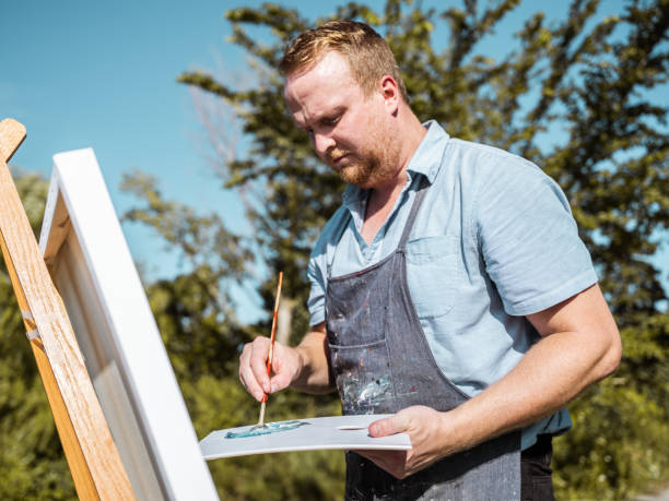 istock Man painting at the Lake shore 1269154941