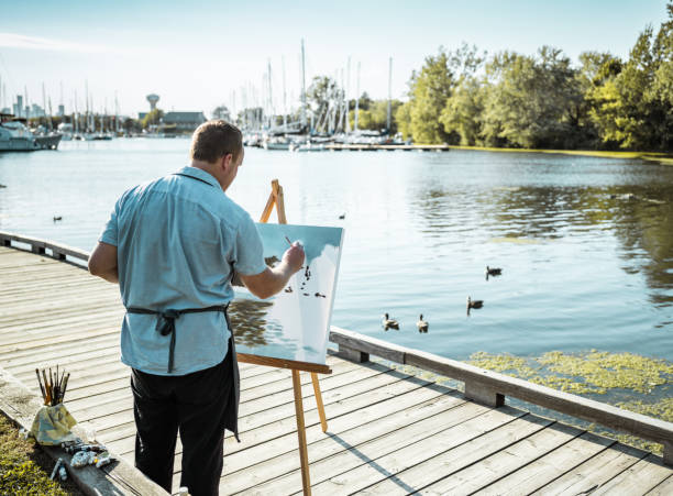 istock Man painting at the Lake shore 1269155078