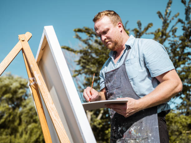 istock Man painting at the Lake shore 1269155624