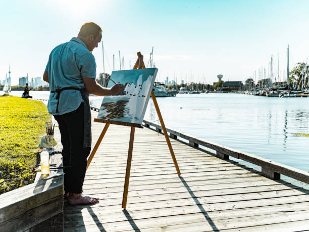 Man painting at the Lake shore