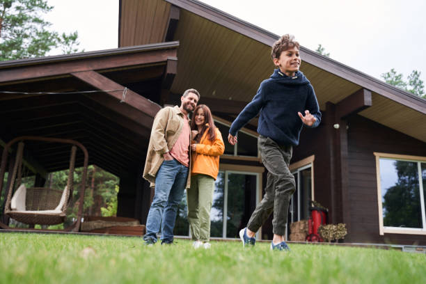 istock Joyful boy spending time with parents outside the house 1269156879
