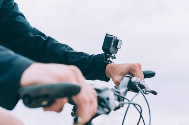 istock Man with an action camera on his hand, rides a bicycle. 1269157317