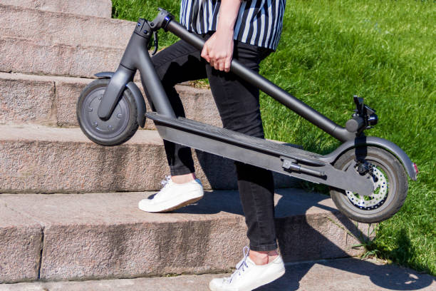 istock Young woman riding electric scooter 1269158155