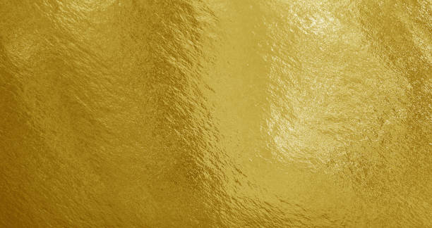 istock Gold foil background with highlights and uneven texture 1269158390