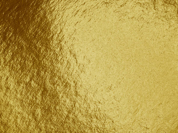 istock Gold foil background with highlights and uneven texture 1269158391